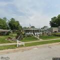 Person experiencing back pain near West Church Street, Palmyra