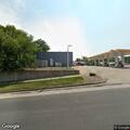 Person sleeping in Shell station driveway