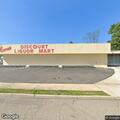 Person experiencing abdominal pain at liquor store