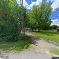 Broken utility pole and low wires block driveway