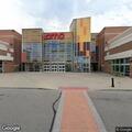 Man urinates beside parked vehicle behind AMC