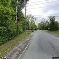 Silver hatchback stopped on roadside in northbound lane
