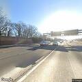 Crash involving white sedan on highway shoulder