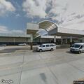 Female falls at top of escalator in airport concourse