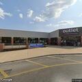 Suspicious occupied vehicle behind furniture store