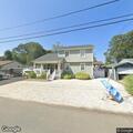 Person experiencing back pain near East Cape May Avenue