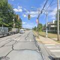 Man walking in traffic on Route 2 near 7th Street