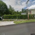 Tree leaning on wires over roadway in Copake