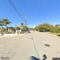 Tree branch falls on gray SUV on Camarillo Street