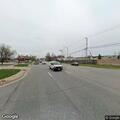 Car leaves roadway and stops on landscaping boulder