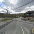 Person pushing shopping cart in middle of road