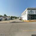Officer with intoxicated person at car detail shop