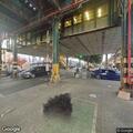 Person sleeping on platform floor at 225th Street station