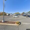 Man lying on ground with seven huskies at Dollar General