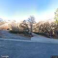 Golf balls hit toward home from nearby hill