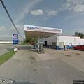 Woman in yellow shirt appears confused by gas station