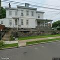 Person experiencing nausea and vomiting at apartment
