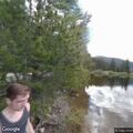 Rescue team assists patient near lake in forest