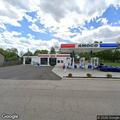Large box truck disabled in front of gas station