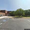 Officer checks black Honda truck at school lot