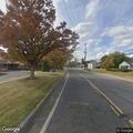 Trees on fire near fence on Main Street property