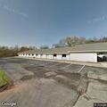 Man screaming in parking lot with tire iron