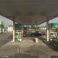 Two men fighting in road near gas station