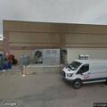 Officer checks possible suspect behind supermarket