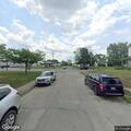 Suspicious person pacing by school in green vehicle