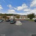 Suspicious man near motel office and open room door