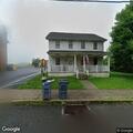 Man lying on sidewalk with bottle near Trumbauersville