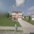 Person repeatedly taking photos of house