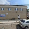 Person experiencing severe back pain at apartment