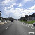Vehicle leaking fluid near gas station sidewalk