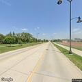 Driver in red pickup braking hard near 12th Street