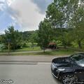 Car parked on walking path at North Park Lake