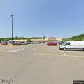 Car stuck on rocks at Walmart parking lot entrance