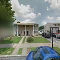 Man repeatedly walking around property in street clothes