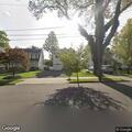Woman smoking marijuana on front lawn