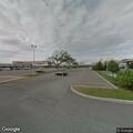 Person lying on sidewalk at Southport Shopping Center