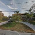 Man camping next to house on Brown Street