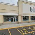 Woman looking into cars at urgent care parking lot