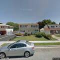 Person suffering from back pain near Bethpage