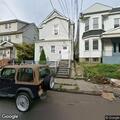 Person experiencing back pain near Ellis Avenue in Irvington