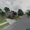 Tree and power lines burning behind Levittown homes