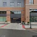 Person requesting hospital sitting on park ledge