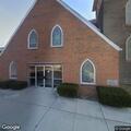 Man with multiple pills behind church
