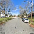 Suspicious person filming homes from white Jeep
