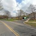Person with severe migraine at college campus