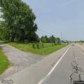 Large unattended fire near outbuilding on highway